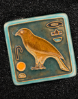 First designed in the 1920s, this hand-painted 3x3 tile depicts the bird hieroglyph Horus, the falcon-headed God of Light.