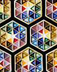 Many Hex Paperweights are places together making an even larger pattern of colorful triangles.