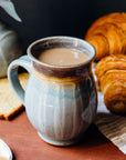 This mug features the glossy pale blue-gray Frost glaze. The lip of the mug is gray.