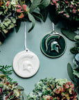 These round, disc-like ornaments feature an MSU Spartan helmet with a large crest.