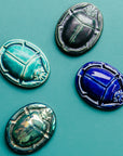 These high relief paperweights feature a scarab beetle with arms tucked in to create a perfect oval shape. 