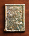 The Three Wise Men Tile features the wisemen in robes holding their three gifts- gold, frankincense and myrrh. They are all facing the right, they seem to be focused on one point beyond the tile. There is a stone wall behind them.