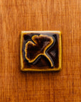 This Ginkgo Tile features the glossy earthy brown Molasses glaze.
