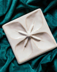 This Geo Flower Tile features the creamy white Birch glaze which has some brown speckling.