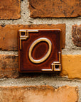 The Craftsman style 0 address number is in the brick reddish brown Carmine Glaze option.