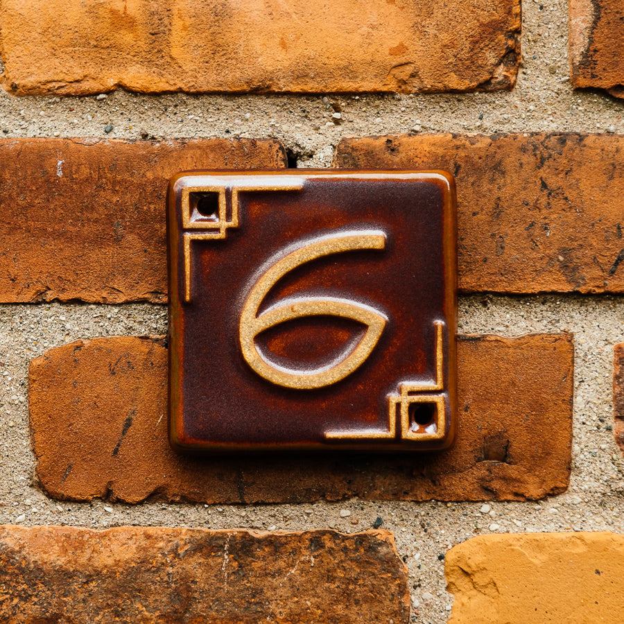 The Craftsman style ceramic 6 address number is in the satin reddish brown Carmine glaze option.