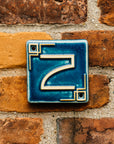 The Craftsman style ceramic 2 address number is in the matte blue Peacock glaze option.