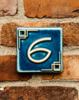 The Craftsman style ceramic 6 address number is in the matte blue Peacock glaze option.