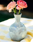 The Bud Vase has a bulbous shape, mimicking the roundness of a flower bud, with slip added to the sides by hand to create a petal-like appearance. From the round bottom emerges an organic tall opening at the top to keep your flowers straight up.