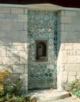 In the center of the design is a metal alcove where water can come out to fill water bottles.