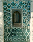 The glossy green Escher Fountain features an almost impossible design. The tiles at the bottom of the fountain are hexagonal and as they move up the wall become three sided cube-looking design.