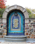 Near the top of the design rests a half bowl where water overflows into the large stone basin below.