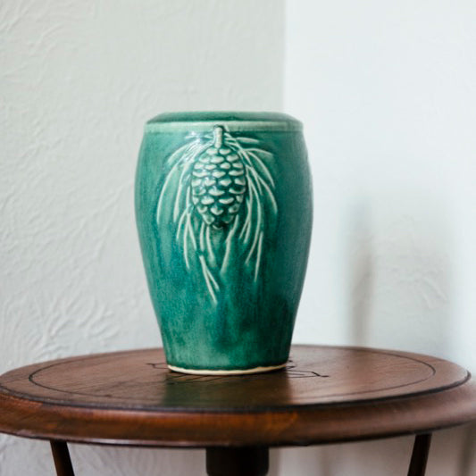 The Pewabic Green vase sits on a round side table.