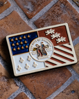 Our hand-painted Detroit Flag Tile is laying on the historic Pewabic tiled floor in our upstairs gallery space. These tiles are a rustic brown and tawny in appearance.