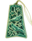 The ornament is glazed in a matte turquoise green color with a pale green ribbon..