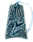 The ornament is glazed in a bright blue color with a pale blue ribbon to hang from.