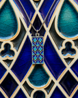 The necklace rests on the Women's City Club tile their blue designs compliment each other.