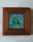 The 4x4 ceramic Michigan tile includes an embossed image of the two peninsulas of Michigan. Encircling these shapes are the words "Enjoy the Beauty and the Bounty, Michigan". The tile features the matte turquoise Pewabic Blue glaze which beautifully offsets the deep reddish brown of the oak wood frame.