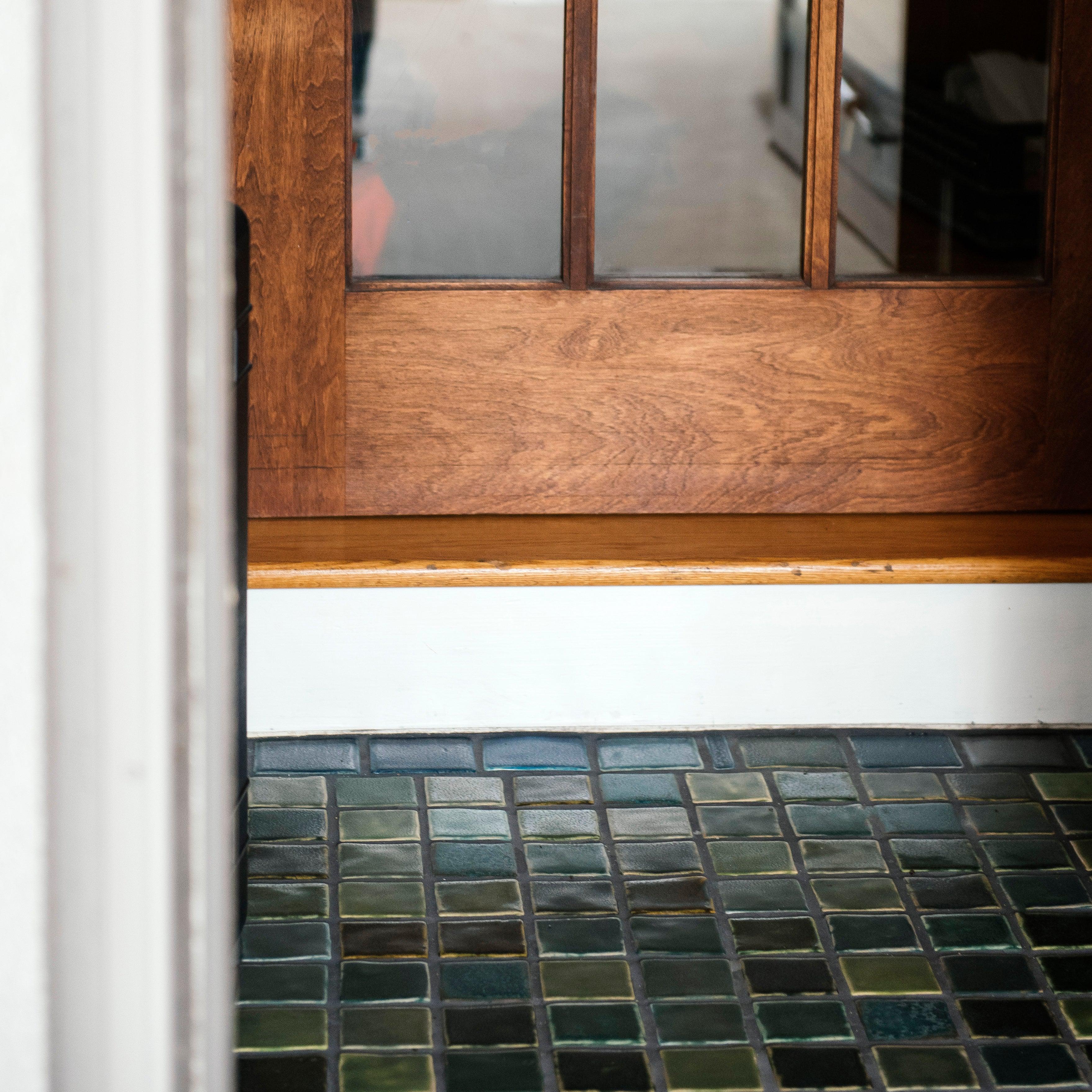 Detailed shot of 3x3 tiles in blue and green surrounded by 3x4 border tiles in grey and blue.