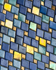 A detail shot of the deep blue and shimmering iridescent tile that lines the exterior dome above the entrance to the Bird House at the Detroit Zoo.