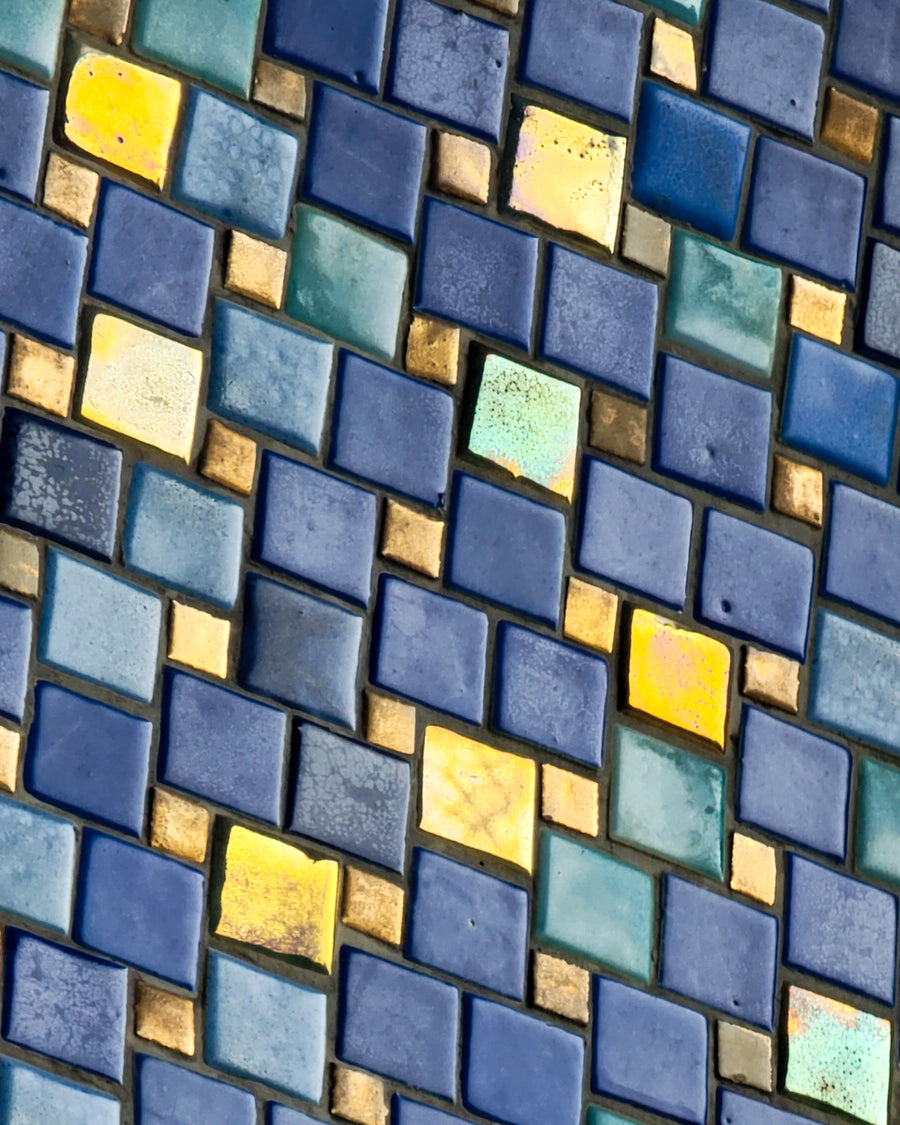 A detail shot of the deep blue and shimmering iridescent tile that lines the exterior dome above the entrance to the Bird House at the Detroit Zoo.