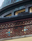 Pewabic Tile details inlaid within the brick just below the dome and covering the arch ceiling leading into the building.