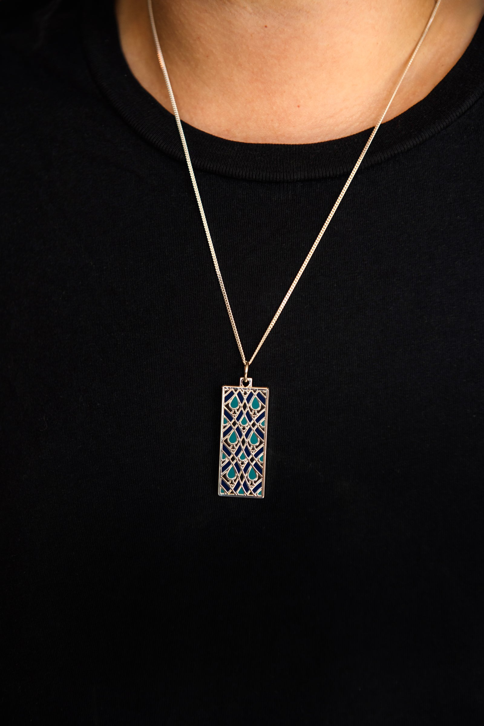 Necklace with a rectangular pendant on a black background