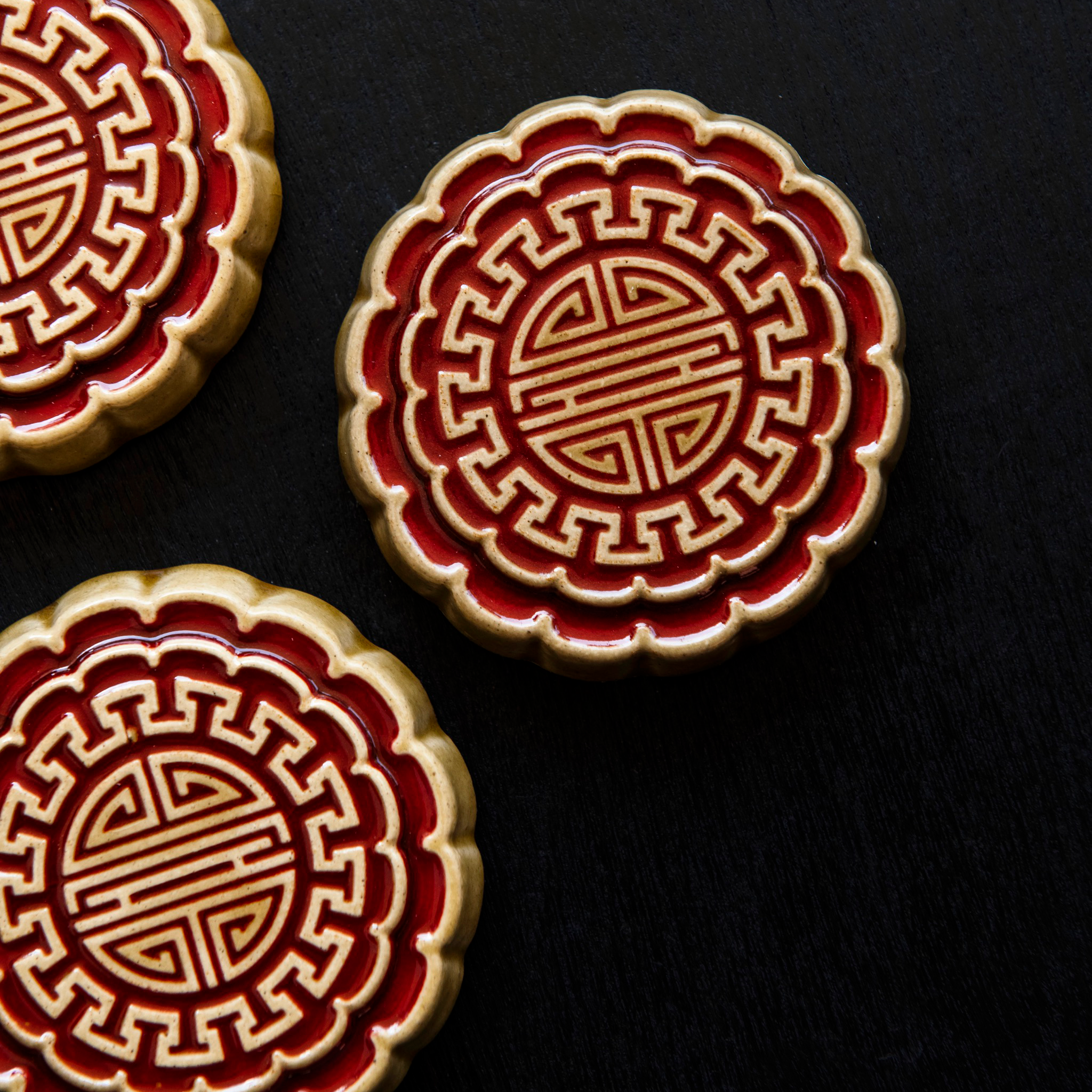 Three Mooncake Paperweights in two-tone Scarlet/Honey.