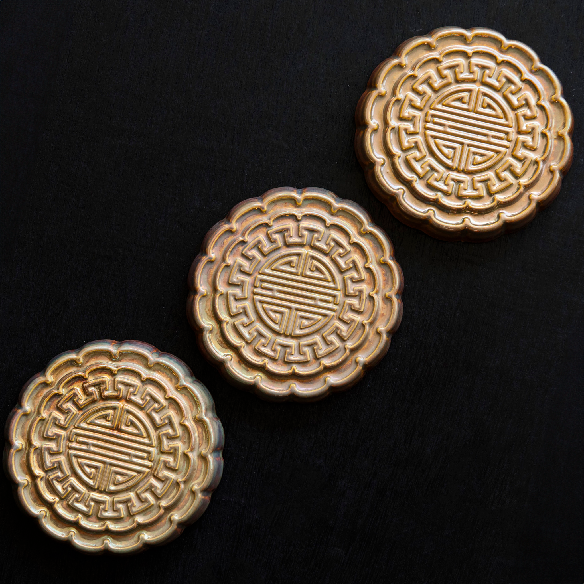 Three Mooncake Paperweights in shimmering Blush Iridescent.  