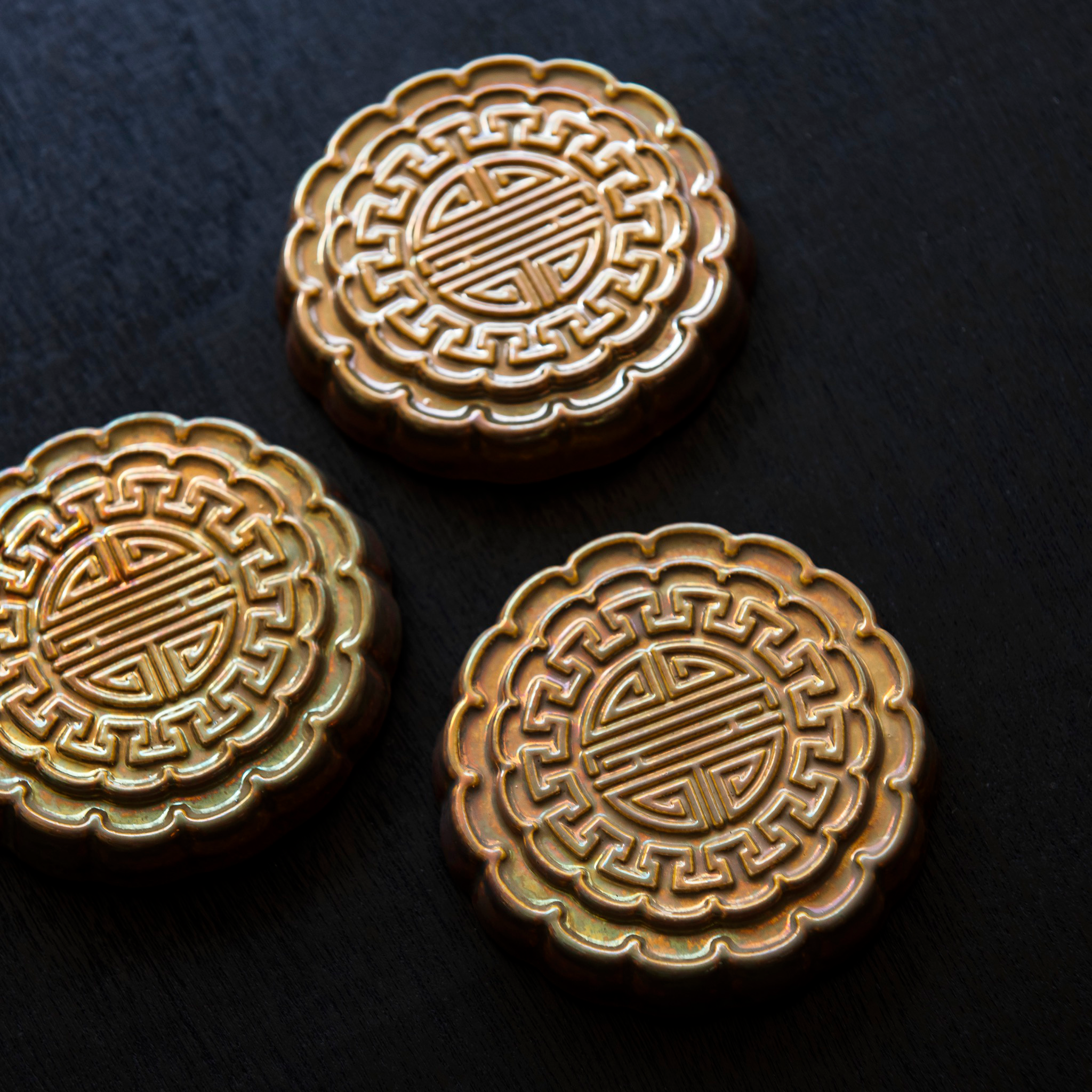 Three Mooncake Paperweights in shimmering Blush Iridescent.  