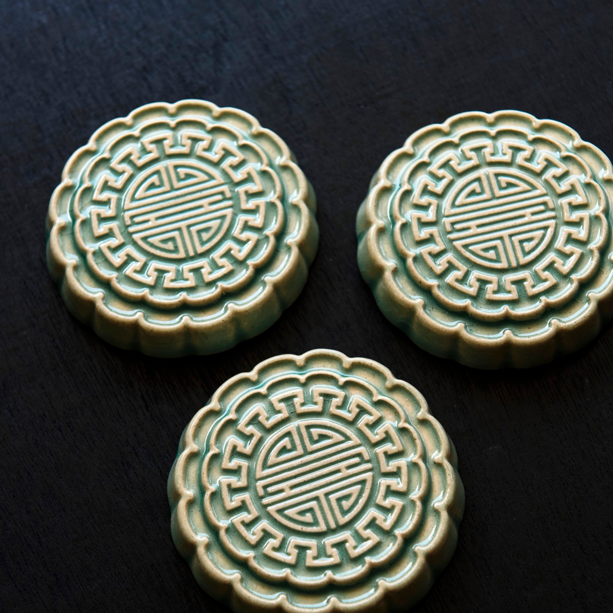 Three Mooncake Paperweights in our glossy Celadon glaze.
