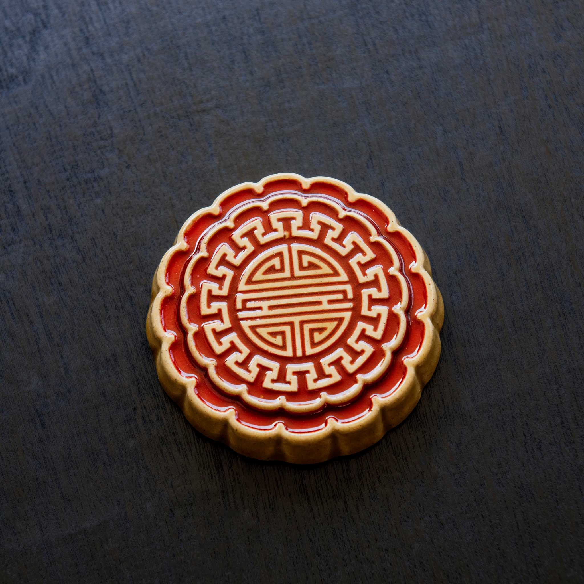 A Mooncake Paperweight in two-tone Scarlet/Honey.