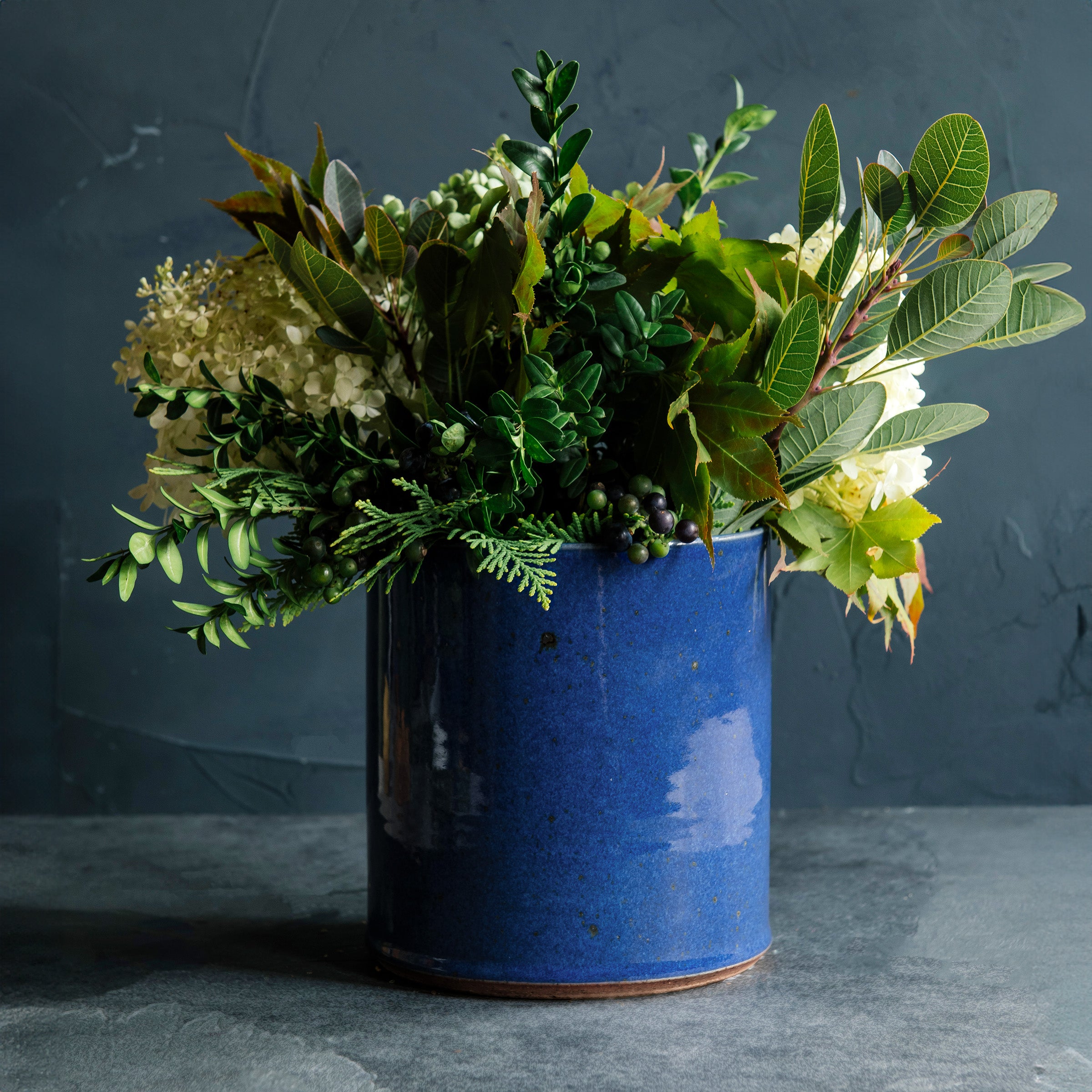 Deep leafy greens are placed artfully into the Ultramarine Crock.