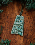 The bell-shaped Two Turtle Doves Ornament features two doves siting on the branches of a leafy tree.