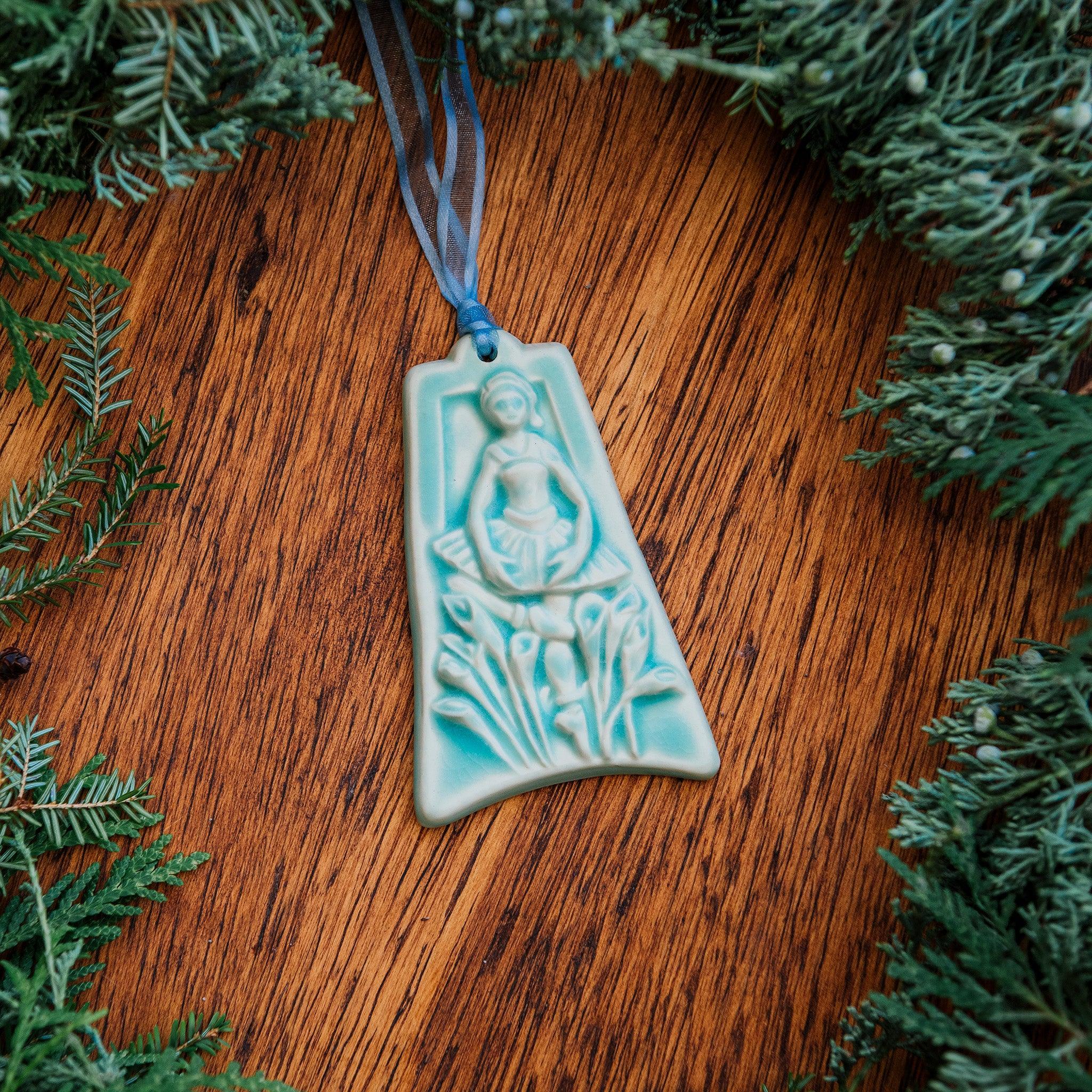 The ornament is glazed in a matte pale blue color.