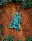 This ornament comes in a matte turquoise green glaze with a pale green ribbon.