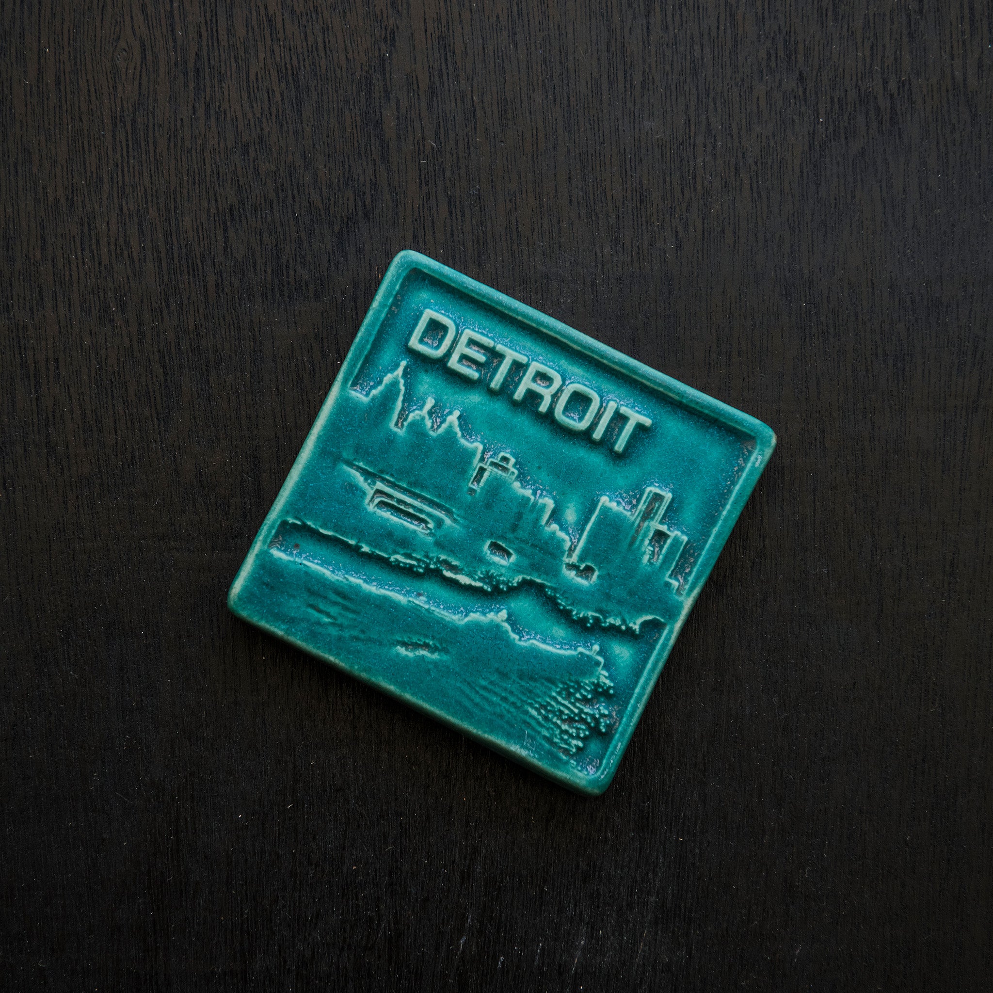  This Detroit Skyline Tile features the matte turquoise Pewabic Blue glaze.