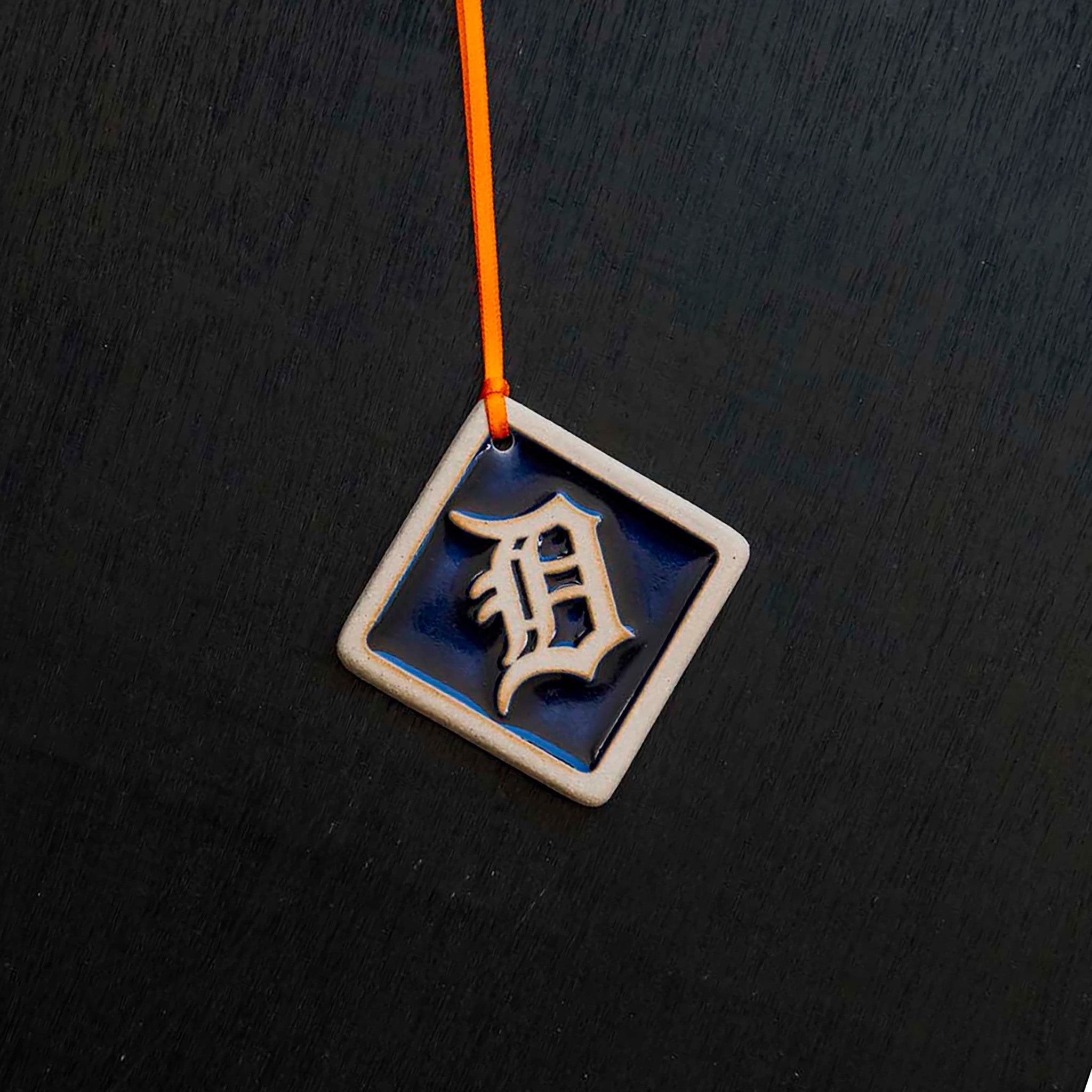 The Navy/Natural color option includes a dark blue background and a scraped cream colored logo and border.