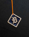 The Navy/Natural color option includes a dark blue background and a scraped cream colored logo and border.