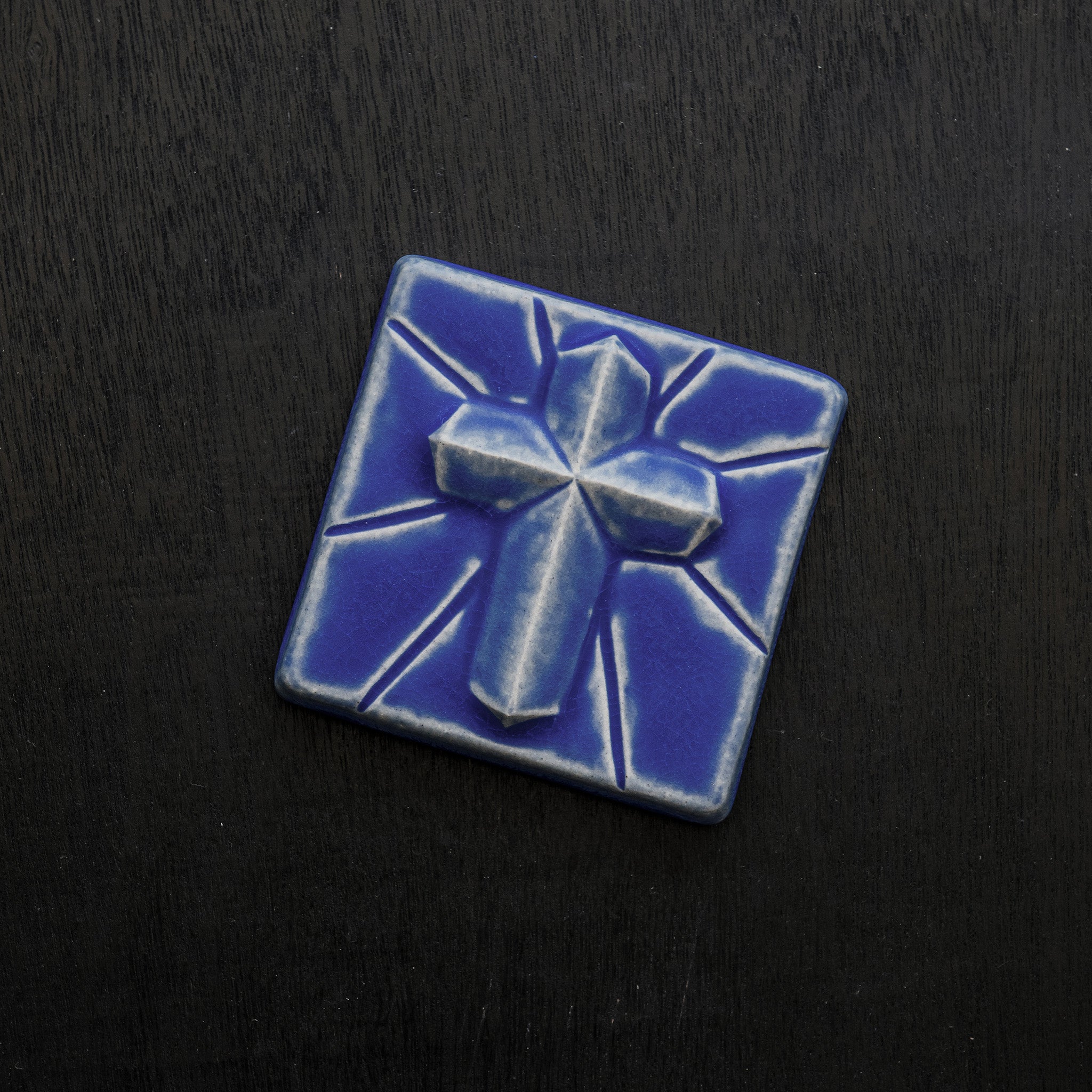 This Mario's Cross Tile features the matte bright steel blue Periwinkle Glaze.