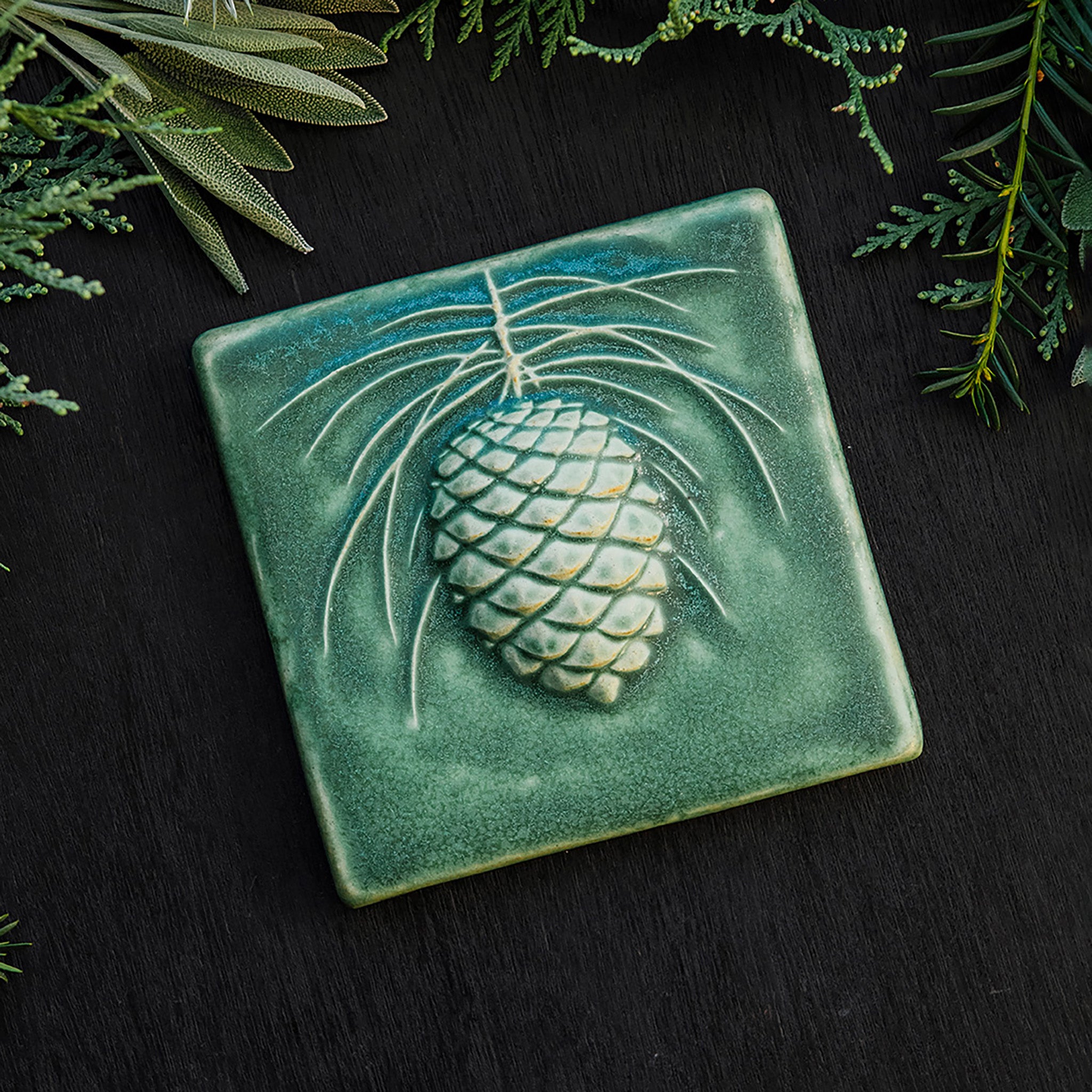 This Ceramic 6X6 Pine Cone Tile is shown in the Leaf green glaze.
