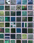 An aerial detail shot of a custom blend of blue and green tiles in a range of textures and glazes.