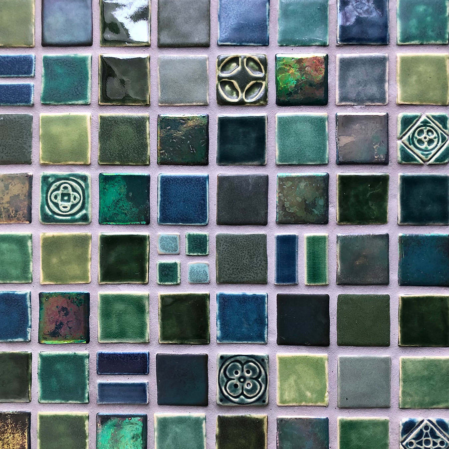 An aerial detail shot of a custom blend of blue and green tiles in a range of textures and glazes.