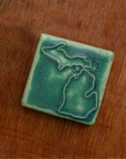 This Michigan Tile features the matte blueish-green Pewabic Green glaze.