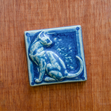 This cat tile is shown in a matte Peacock blue glaze.