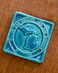 This Beauty and Bounty of Michigan tile is featured in the matte Pewabic Blue glaze.