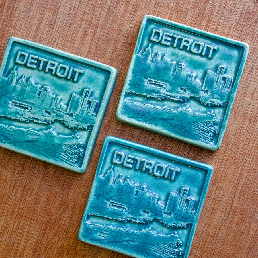  This Detroit Skyline Tile features the matte turquoise Pewabic Blue glaze.