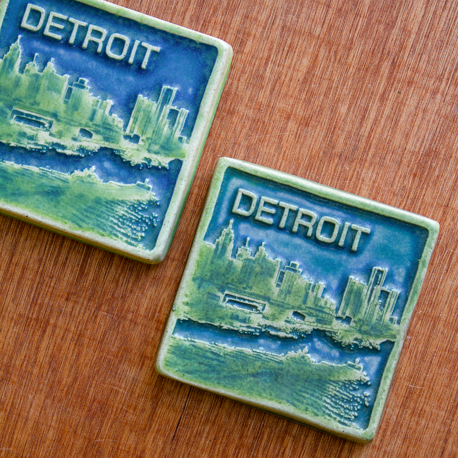 This two-tone Detroit Skyline tile is featured in the Lime/Lagoon color palette. The sky and water are in the matte blue Lagoon glaze and the skyline, boat, and word is in the matte bright light green Lime glaze.