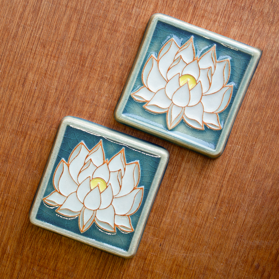 The Lotus tile features a line drawing of a blooming lotus flower, its pointed petals outstretching. It has a simple border around the design.