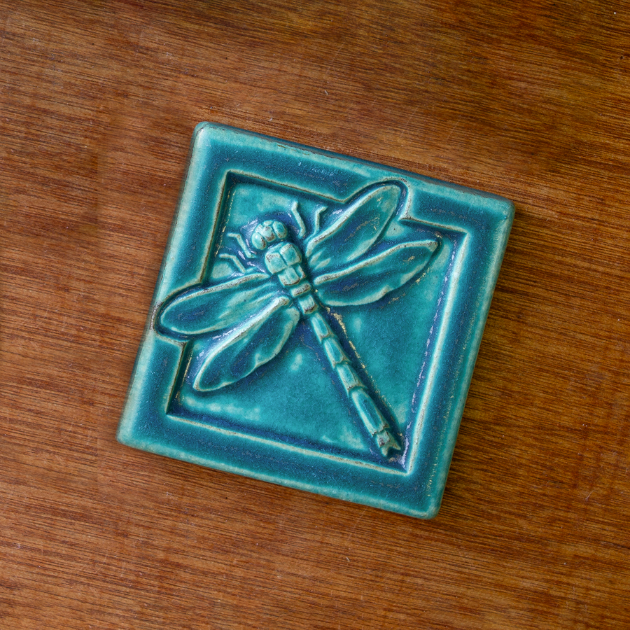 This Dragonfly Tile features the matte turquoise Pewabic Blue glaze.